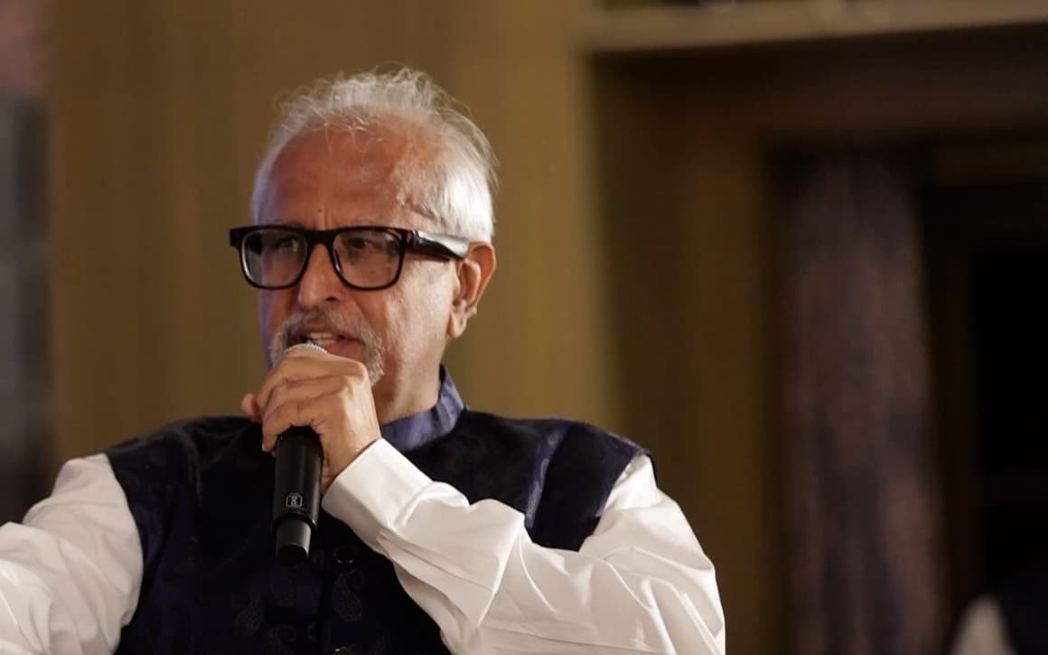Ramesh Sadhwani close up, mid-sentence with a microphone in hand